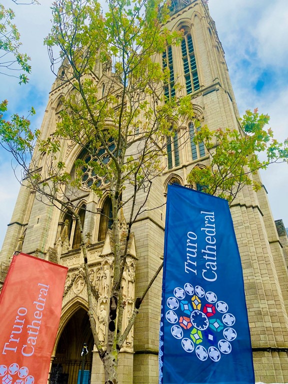 front of the cathedral looking up with Truro Cathedral feather flags