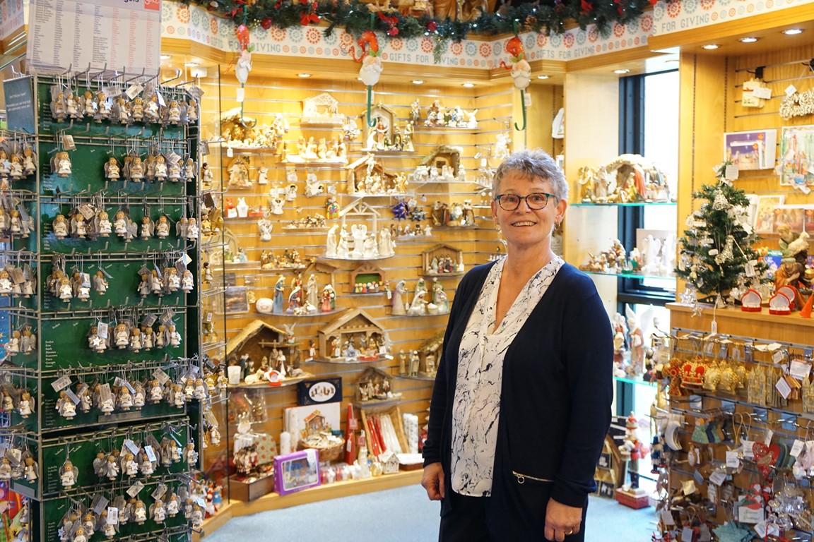 Truro Cathedral shop supervisor Celia Bray standing inside the shop