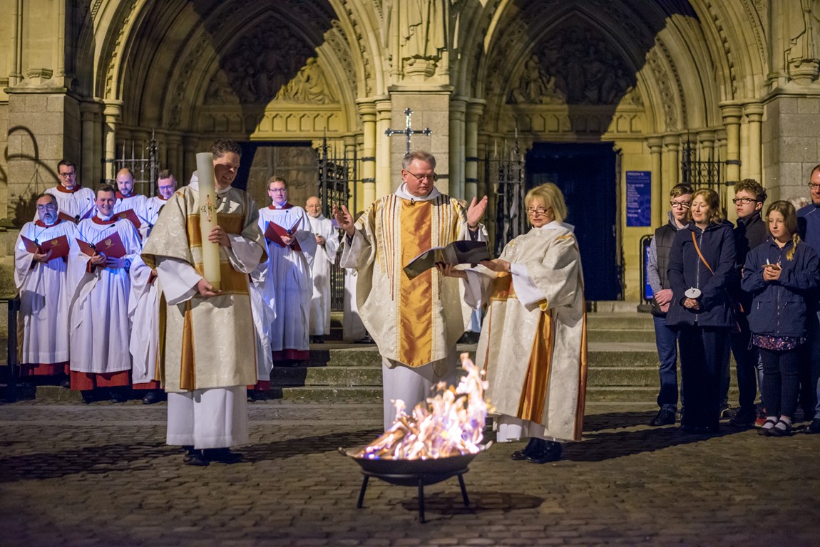 Roger Bush Dean of Truro Cathedral on High Cross outside of Truro Cathedral around firepit and reading prayers