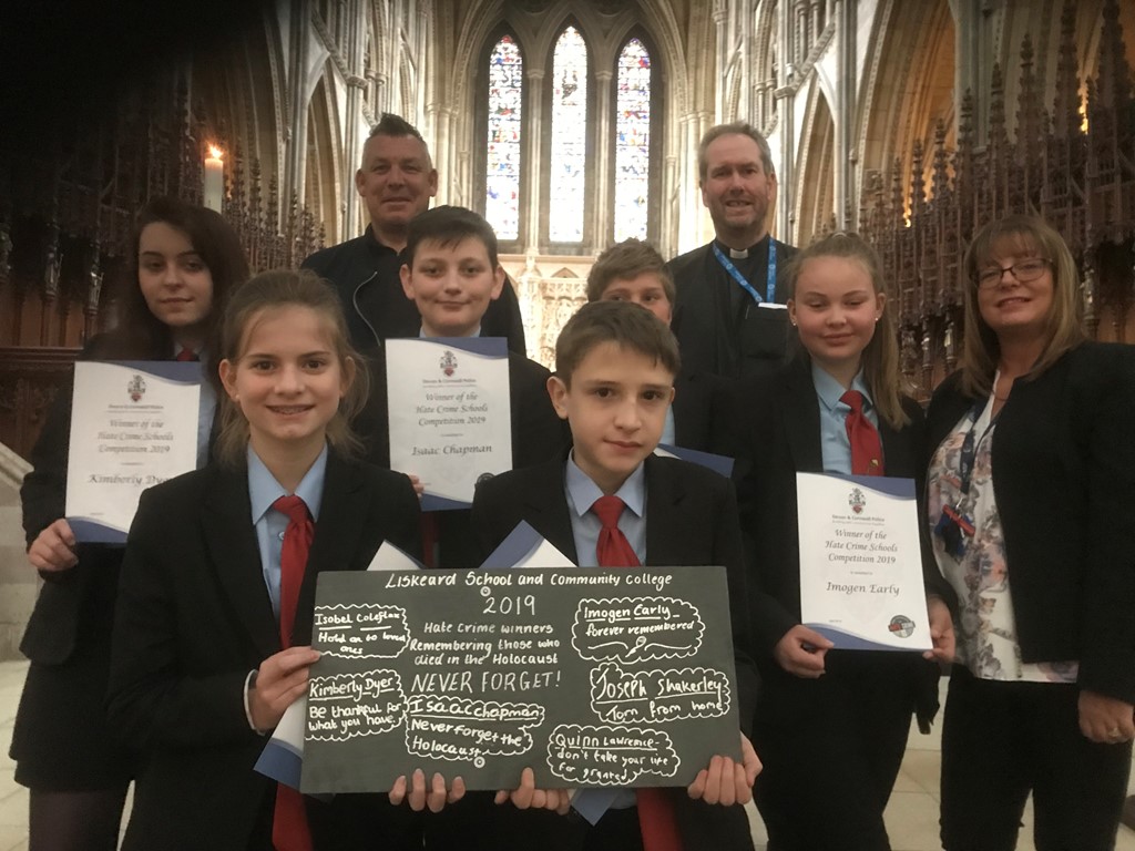Rev'd Alan Bashforth of Truro Cathedral with teachers and pupils from Liskeard Community School holding up a roof slate with hand written messages