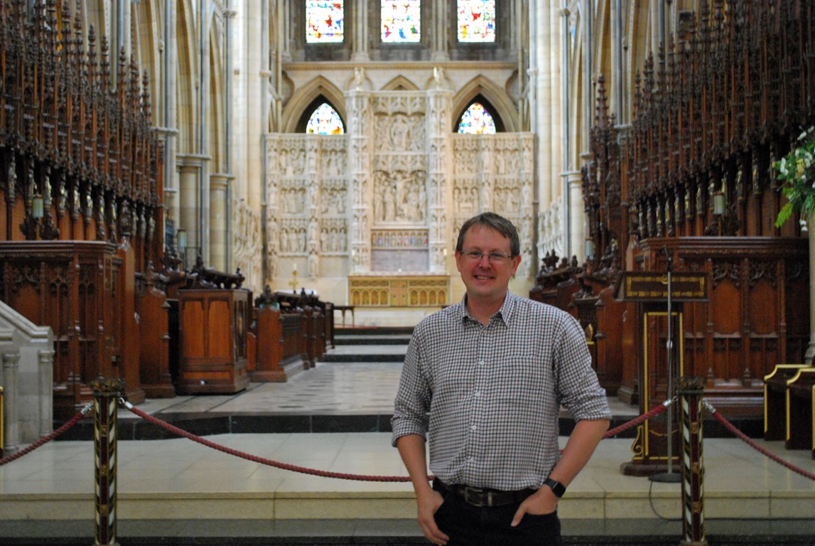 Sean O'Neill standing inside Truo Cathedral in front of the high altar