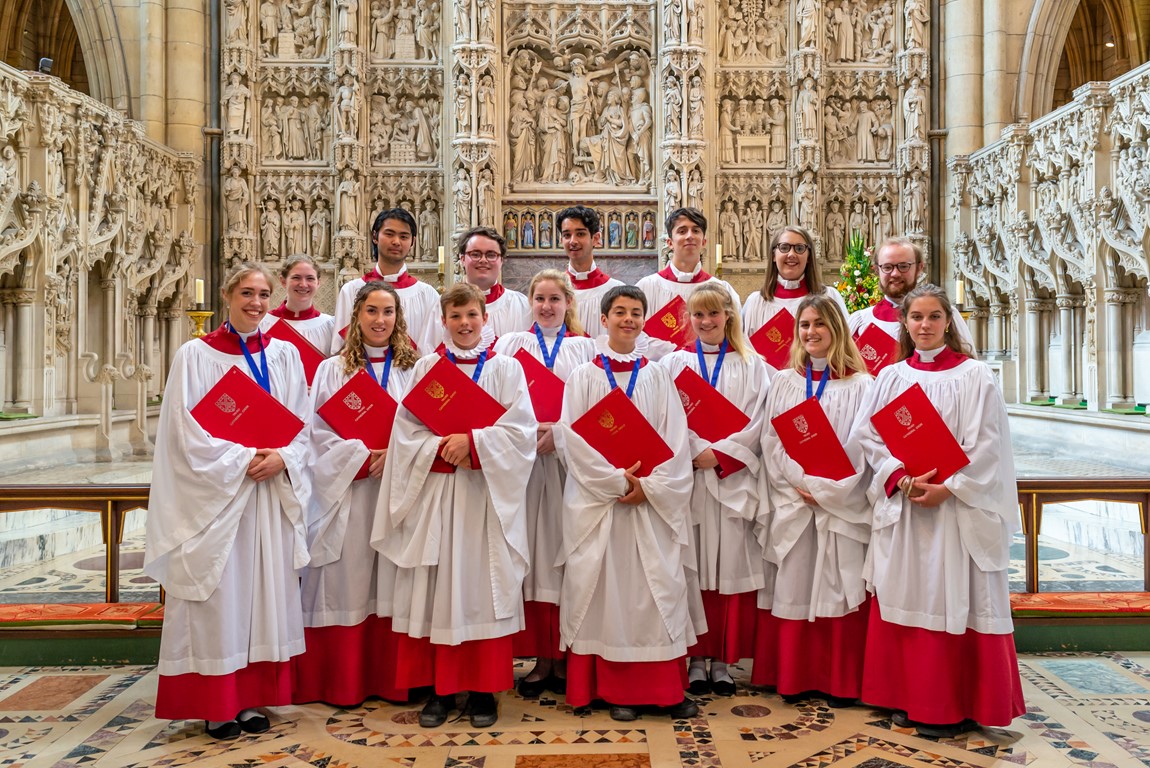 Members of Truro Cathedral choral foundation standing in front of the high altar in the cathedral