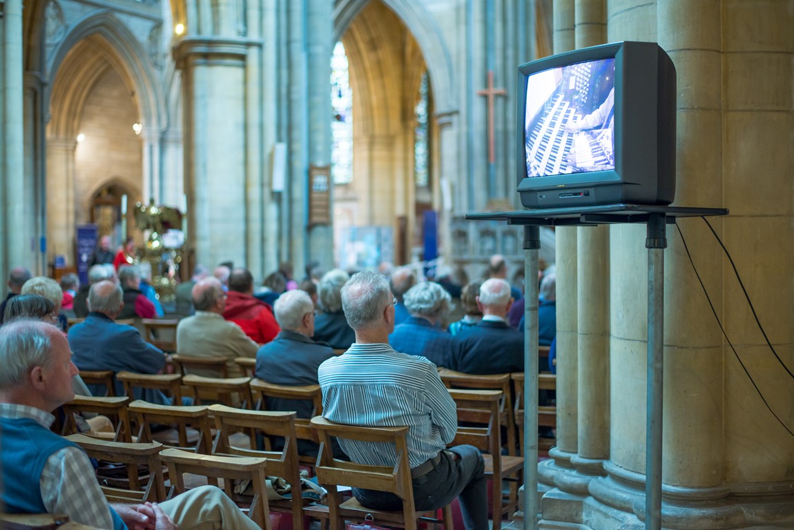 People sitting inside Truro Cathedral listening to a lunchtime organ recital