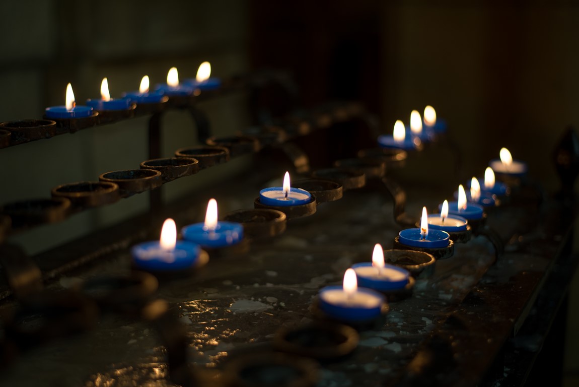 Close up of lit candles on the pricket stand in Truro Cathedral