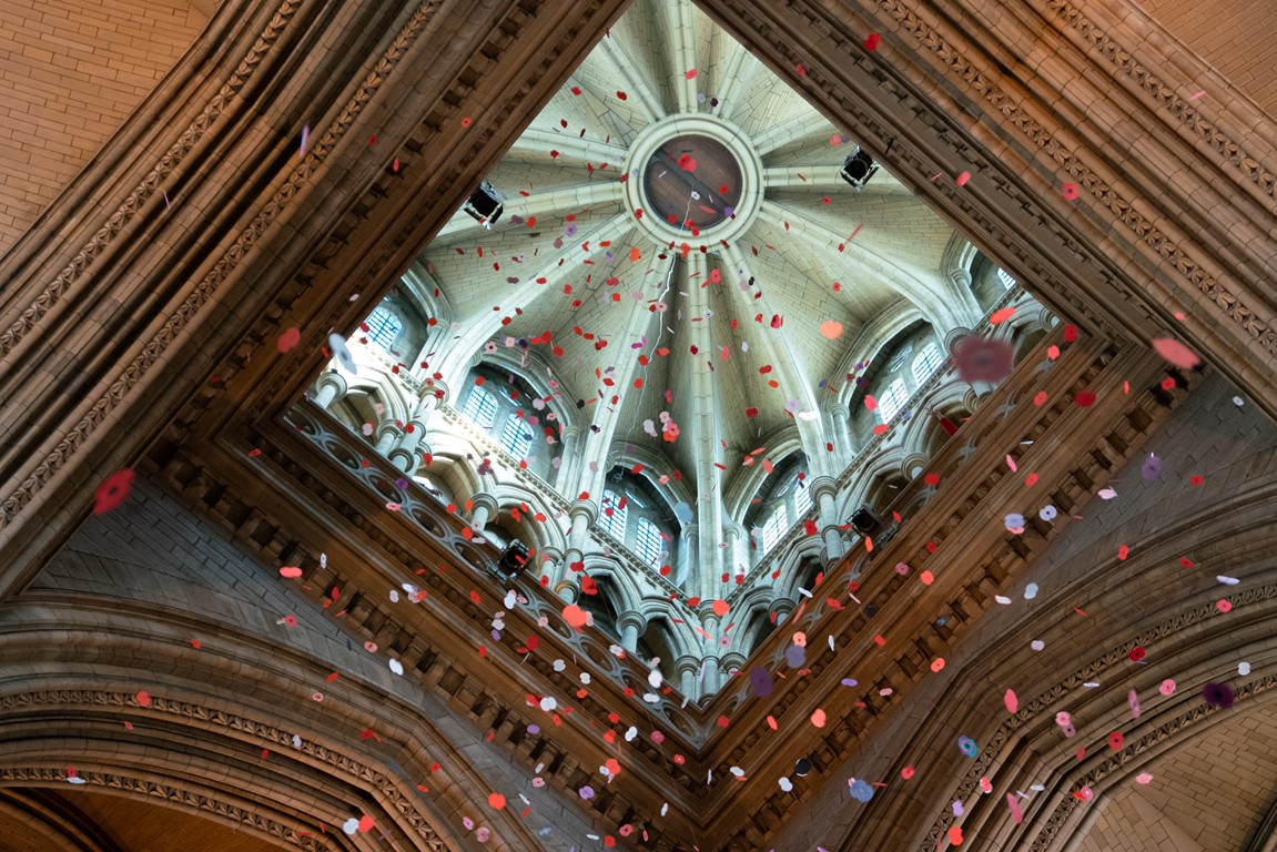 looking up at paper poppies falling down from central tower within Truro cathedral